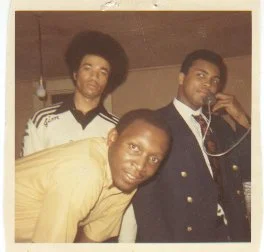 Jim Watkins, Muhammad Ali, and Charlie Lipscomb (Tech's first Black scholarship basketball recruit & a Groove brother), at the Groove Phi Groove house in 1970.  This was during the time Ali was stripped of his title.